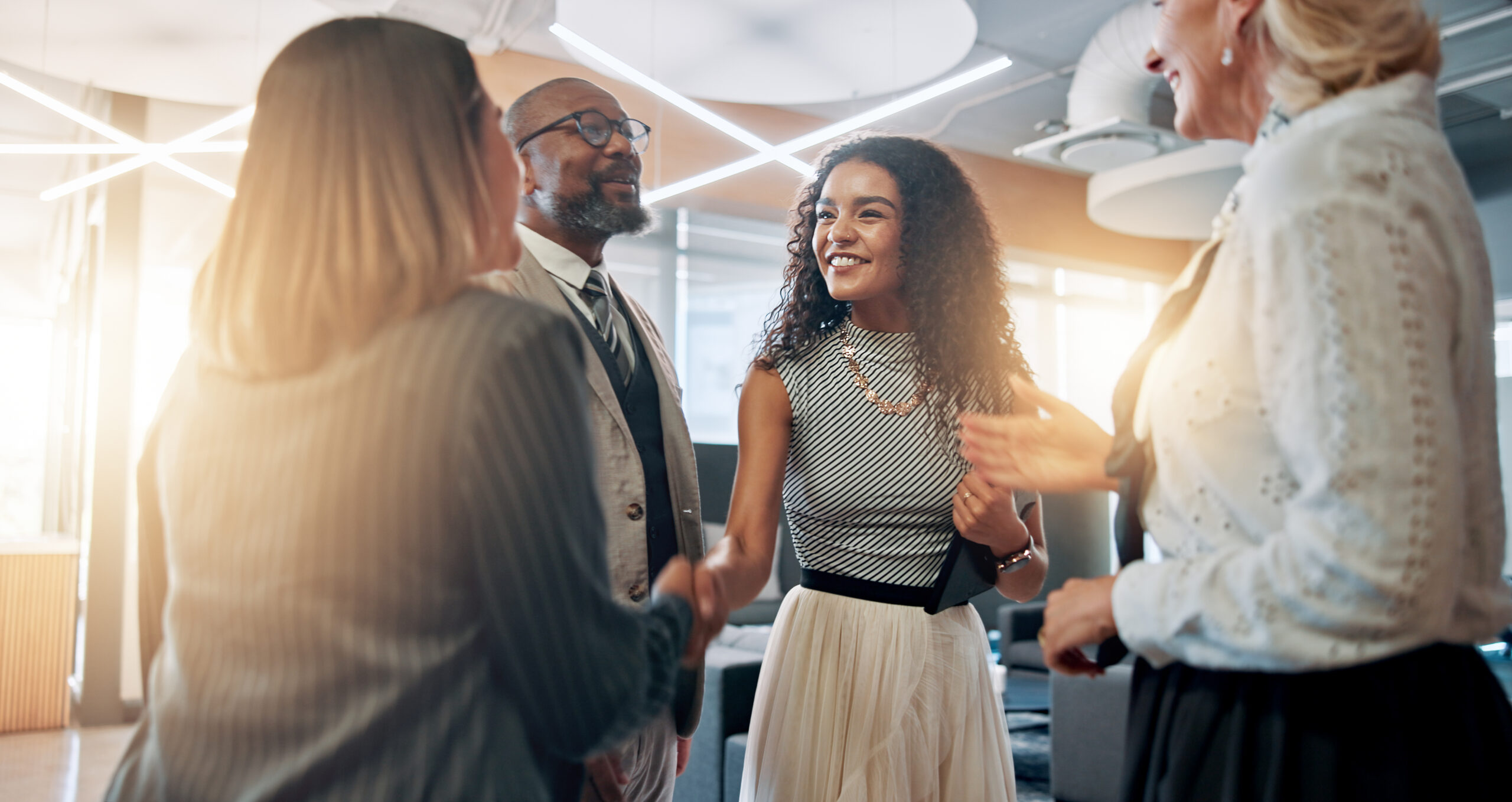 Meeting, handshake and business people in office for partnership, agreement and thank you. Corporate, teamwork and happy men and women shaking hands for collaboration, success and b2b networking